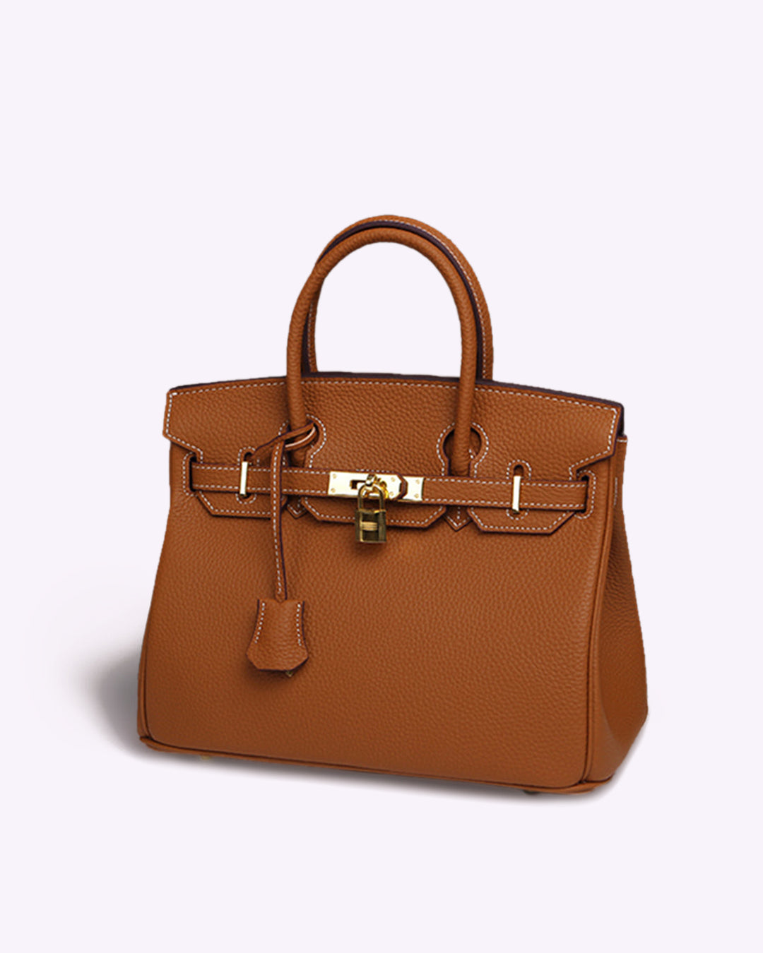 Tan structured tote bag with gold lock detail and top handles on a plain background