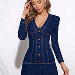 Fitted dark denim mini dress with long sleeves, deep V neckline, and gold button-down front