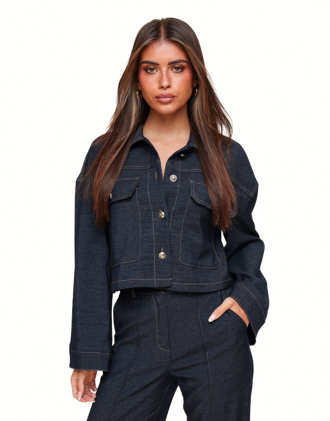 Dark blue cropped denim jacket with contrast stitching flap pockets and button closure designed for women by Sophia and Grace London