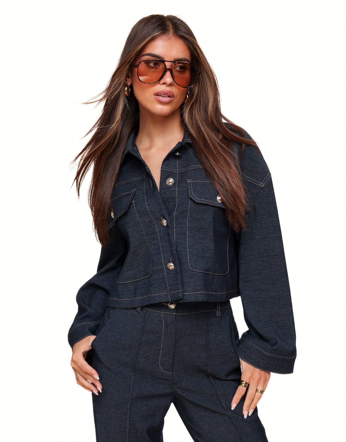 Dark blue cropped denim jacket with contrast stitching flap pockets and button closure designed for women by Sophia and Grace London