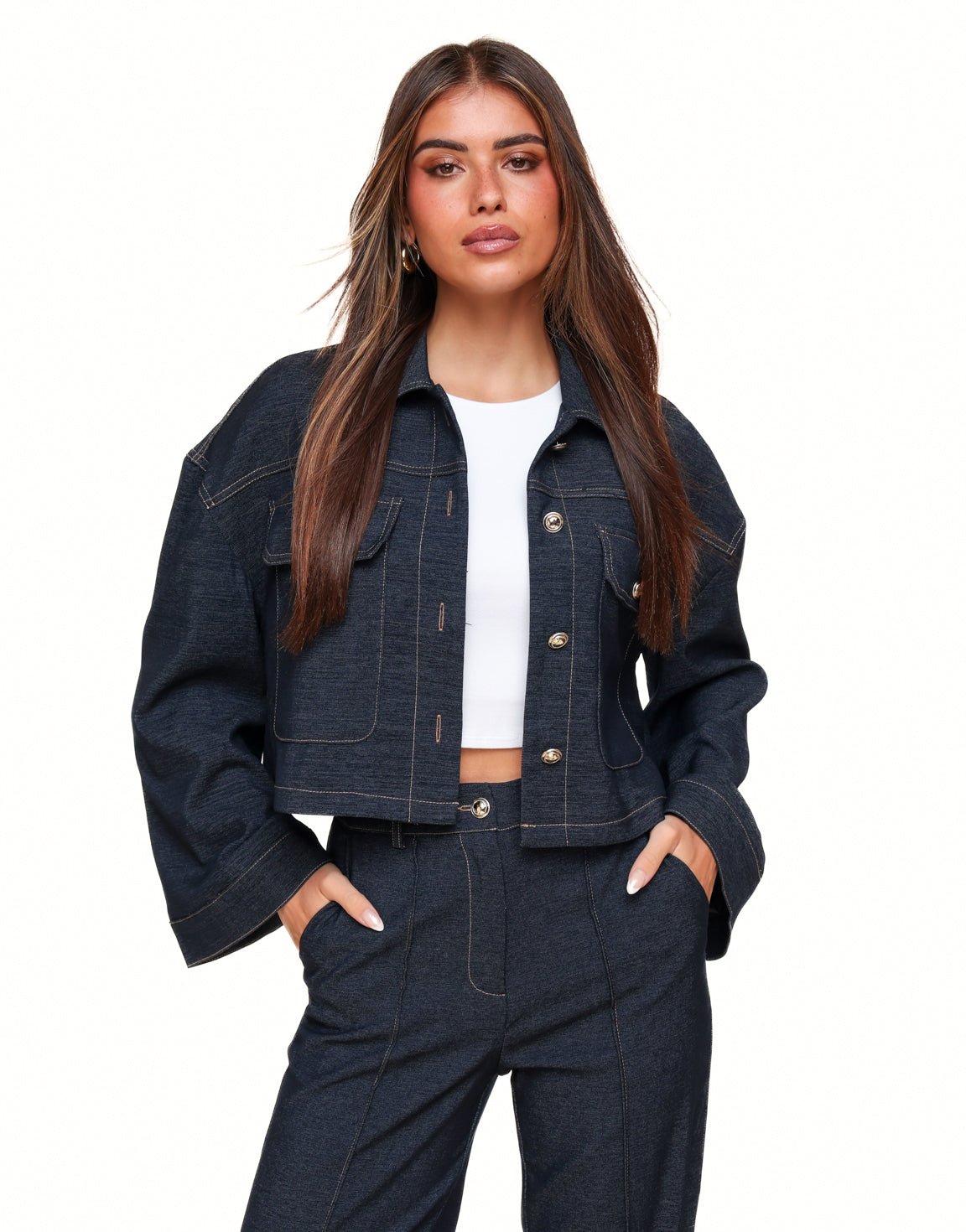 Dark blue cropped denim jacket with contrast stitching flap pockets and button closure designed for women by Sophia and Grace London