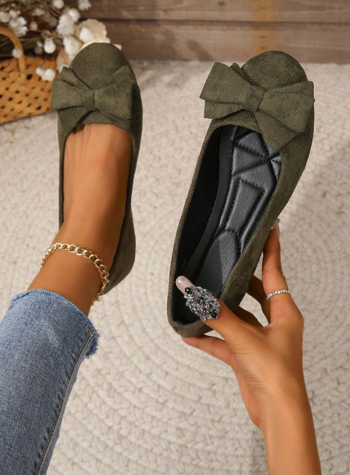 Women's suede-look bow flats in black, burgundy, and olive green with a square toe and cushioned insole