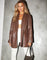 Woman wearing tailored leather-look blazer in chocolate brown with oversized fit and clean lapels